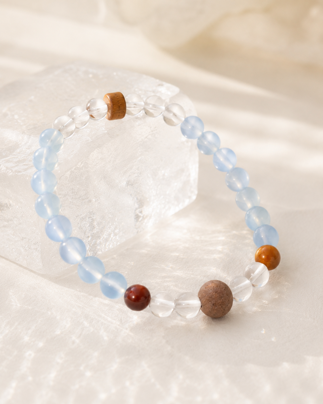 Close-up of aquamarine, clear quartz, Kuka bodhi, sandalwood, and incense bead